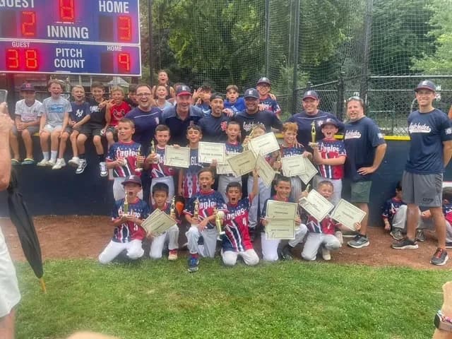 Eagles baseball team with trophies and certificates