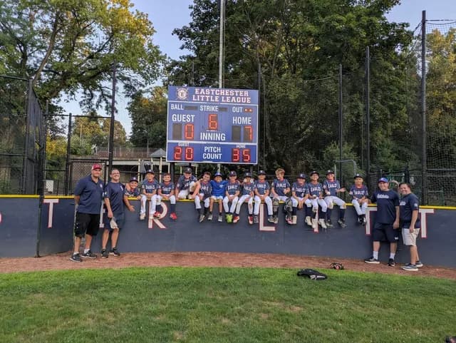 Eastchester Little League baseball team photo with scoreboard
