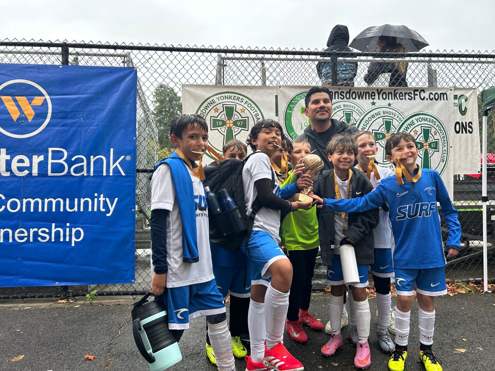 Eastchester little baseball team players posing with trophy